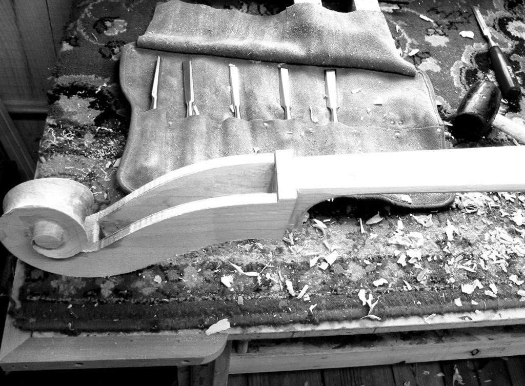 upright bass scroll being carved