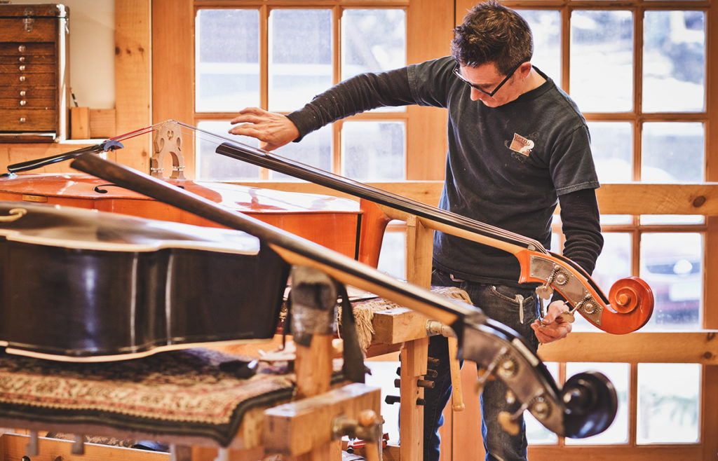luthier working on a double bass